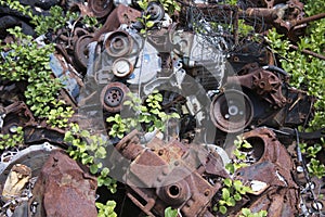 Rusting scrap metal pieces in junkyard