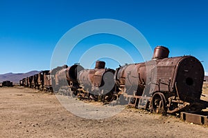 Rusting steam trains and carriages slowly rot away at the train graveyard just outside of Uyuni, Bolivia