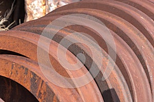 Rusting train wheels stacked in siding