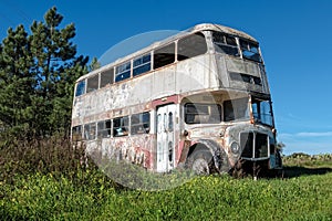 Rusty Abandoned Double-Decker Bus Standing in a Field