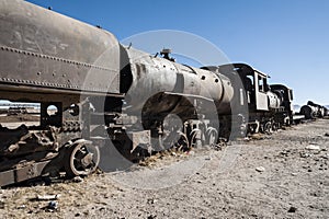 Rusty and abandoned old trains at the Train Cemetery Cementerio de Trenes in Uyuni desert, Bolivia photo