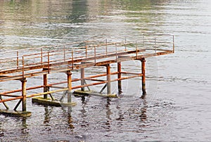 Rusty abandoned pier in sea