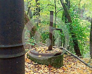 Rusty abandoned pumps on a disused well in the wilderness