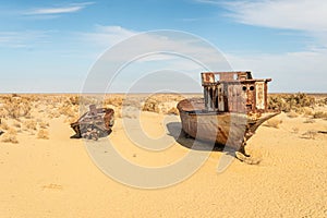 Rusty abandoned ships at the Ship cemetery at the former Aral sea coast in Moynaq Mo ynoq or Muynak , Uzbekistan