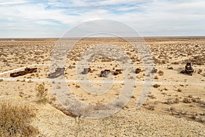 Rusty abandoned ships at the Ship cemetery at the former Aral sea coast in Moynaq Mo ynoq or Muynak , Uzbekistan