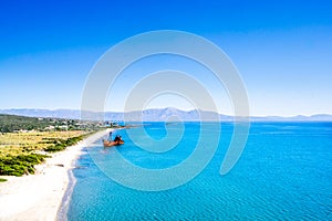 Rusty and abandoned shipwreck on a coastline near Gythio in Lakonia, Peloponnese Greece