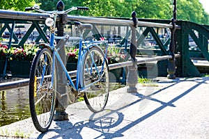 Rusty abandoned vintage retro bike parked by a bridge