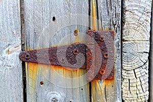 Rusty aged iron hinge weathered gray wood door