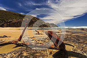 Rusty Anchor in the Rocks on the Sea Shore