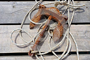 Rusty anchor. Wooden background