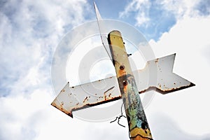 Rusty arrow signpost