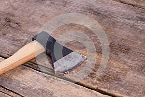 Rusty axe on old wooden floor.