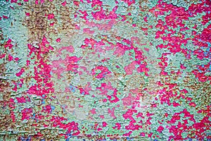 Rusty background. A rusty old metal plate with cracked green and pink gloss paint