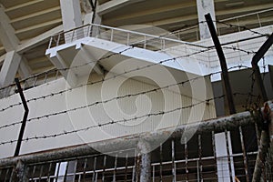 Rusty barbed wire in front of an old football stadium