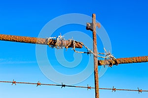 Rusty barbed wire old rough rusted metal posts