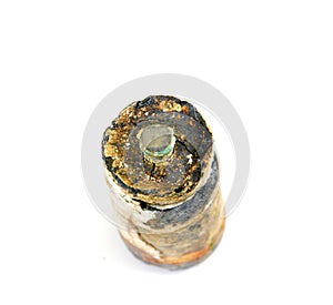 rusty battery on white, energy and pollution theme