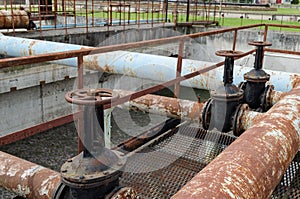 Rusty big tap and pipes and water treatment liquid