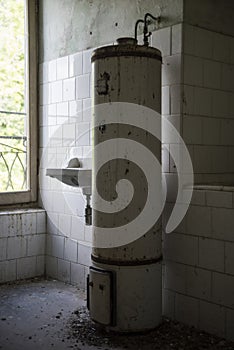 A rusty big white boiler