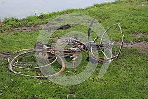 Rusty bikes on the water\'s edge after dredging the ring canal