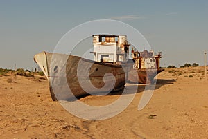 Rusty boat shell lying in the sand