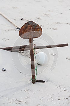 Rusty boats anchor solid in the sand