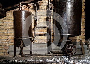 Rusty boiler room pipes. Old metal boiler generating heating and delivering it to home through pipeline. Hot water or gas is being