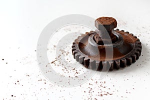 Rusty bolt, nut and gear wheel made of chocolate isolated on white background