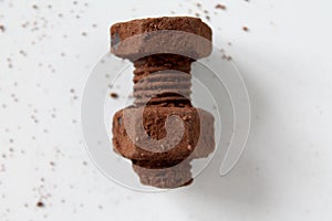 Rusty bolt and nut made of chocolate isolated on white background