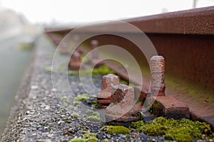 Rusty bolt, screw and screw nut of old light rail steel beam