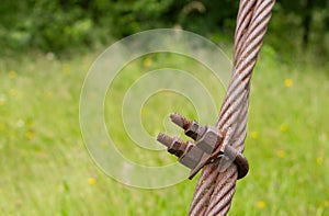 Rusty, bolted metal wire rope for suspension bridge.