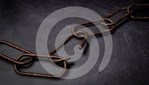 Rusty broken chain, on dark