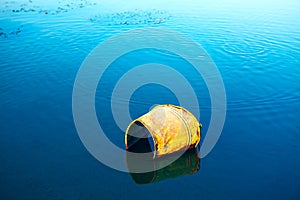 Rusty bucket in the lake water