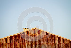 Rusty Building Wall, Roof and Chimney. Copy Space. Clear Day