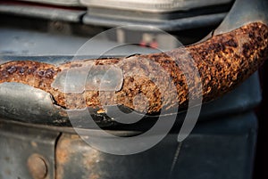Rusty bullbar of an old auto.