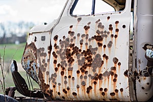 Rusty bullet holes in the door start the truck