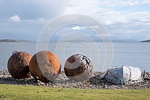 Rusty buoys on the beach at Polbain, north of Ullapool, on the west coast of Scotland.