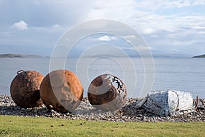 Rusty buoys on the beach at Polbain, north of Ullapool, on the west coast of Scotland. photo