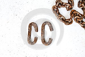 Rusty c-shaped scrapers and chain on white background