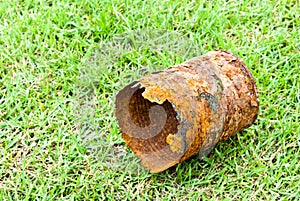 Rusty can on green grass