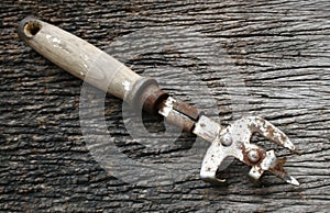 Rusty can opener with wood handle