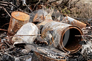 A rusty cans which were pressed down, burned and thrown away as ecology problem
