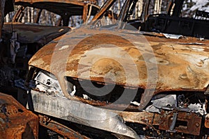 rusty car that burned at a scrapyard