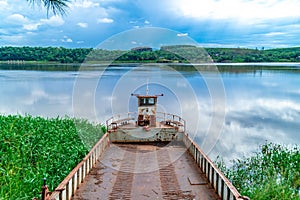 rusty cargo ship by the river in south america