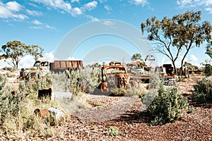 Rusty cars trucks and other items in the desert