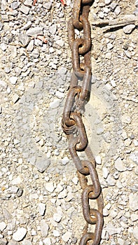 Rusty chain detail on dry ground