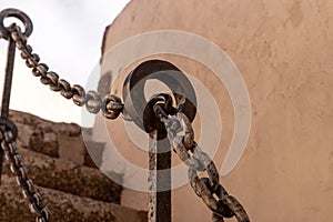 Rusty chain links. Railings chain in a staircase