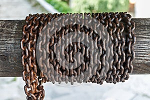 Rusty chain on a log.