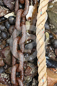 Rusty Chain and Rope on Pebble Beach