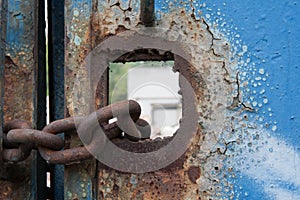 Rusty chain and ruins of old factory