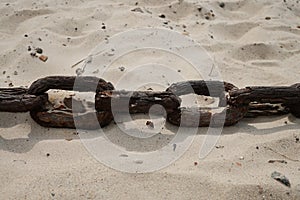 Rusty chain in the sand on the beach